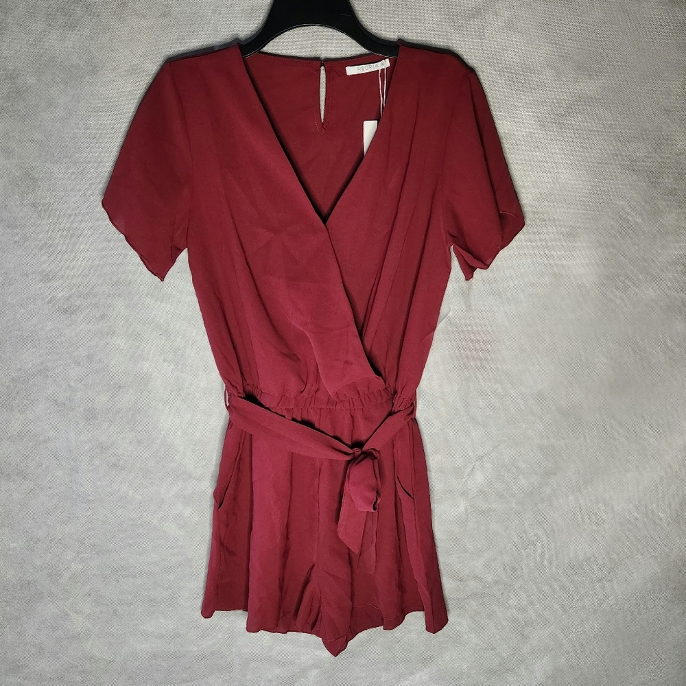 Reoria Maroon Short Sleeve Romper Features A Flattering V-Neckline Self-Tie Belt